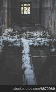 Close up abandoned house corridor with destroyed snowed wooden floor concept photo. Front view photography with blurred background. High quality picture for wallpaper, travel blog, magazine, article. Close up abandoned house corridor with destroyed snowed wooden floor concept photo