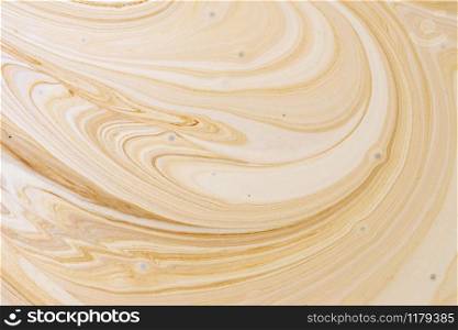 Close-up abstract caramel shapes latte art in coffee. Liquid texture background macro.