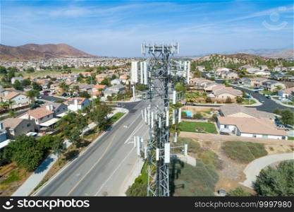 Close-up Aerial of Cellular Wireless Mobile Data Tower with Neighborhood Surrounding.