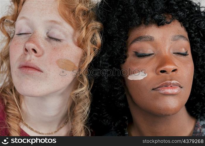close up african caucasian woman s face with skin tone foundation cream cheek
