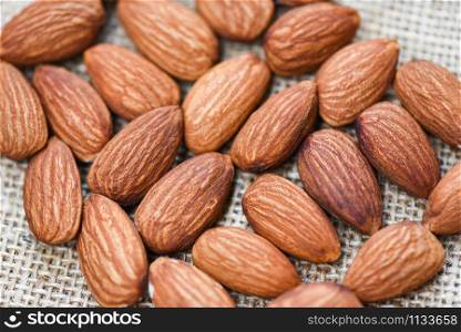 Close up almond nuts natural protein food and for snack / Almonds on sack background