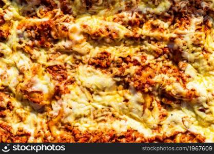 Close up and top view of a freshly baked homemade lasagna ready for serving.