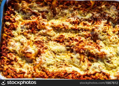 Close up and top view of a freshly baked homemade lasagna ready for serving.