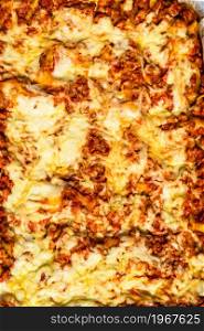 Close up and top view of a freshly baked homemade lasagna ready for serving.