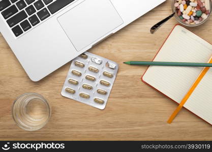 Close up antivirus set with pills blister pack and laptop. Antivirus set with pills blister pack and laptop on table