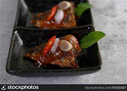 Close up Appetizers with the spicy sardine in ceramic tray, copy space