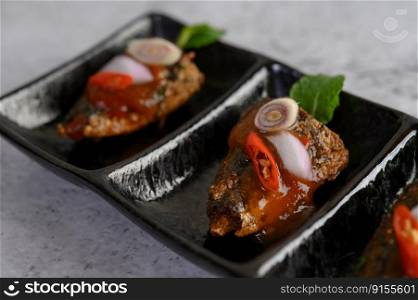 Close up appetizers with the spicy sardine in ceramic tray, copy space