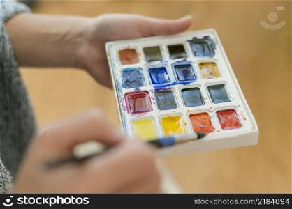close up artist holding color palette