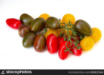 Close up assortment of red, yellow and green tomatoes