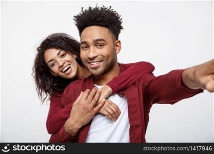 Close up attractive African American couple making a selfie with cute gesture. Close up attractive African American couple making a selfie with cute gesture.