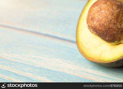 Close-up Avocado (Persea americana) turning brown on wooden table.