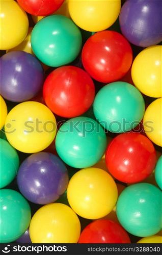 Close up background of colorful plastic play balls.