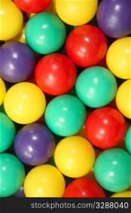 Close up background of colorful plastic play balls.