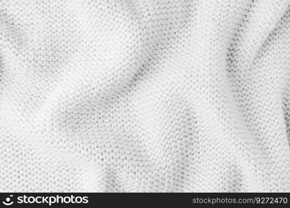 Close up background of knitted wool fabric made of viscose yarn. White color crumpled knitting wool knitwear texture. Abstract knitted wrinkled jersey fabric backdrop, wallpaper. Pastel turquoise knitwear wool fabric texture background. Abstract textile backdrop