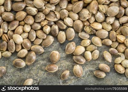 close up background of unshelled hemp seeds on a slate stone