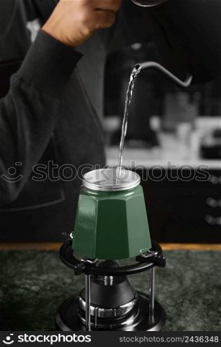 close up barista pouring hot water