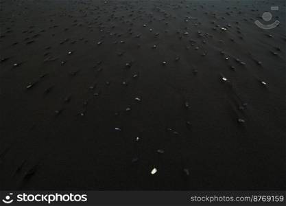 Close up basalt rocks on beach concept photo. Beauty of nature. Front view photography with black sand on background. High quality picture for wallpaper, travel blog, magazine, article. Close up basalt rocks on beach concept photo