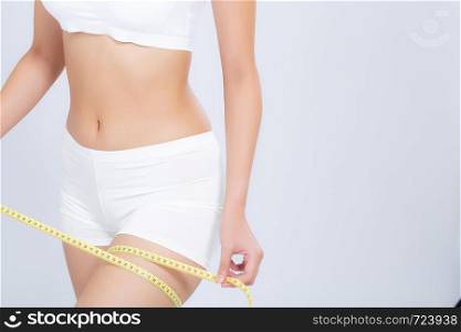 Close up beautiful woman measuring thigh and leg size with tape isolated on white background, girl diet cellulite of a body fit, health and weight concept.