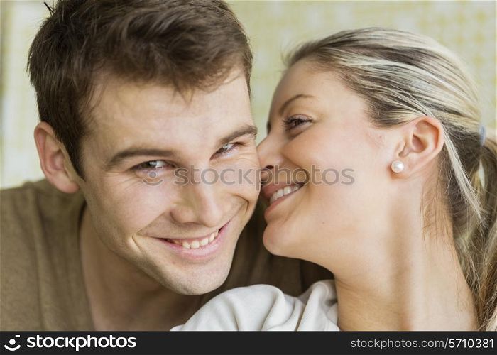 Close-up beautiful young woman kissing man