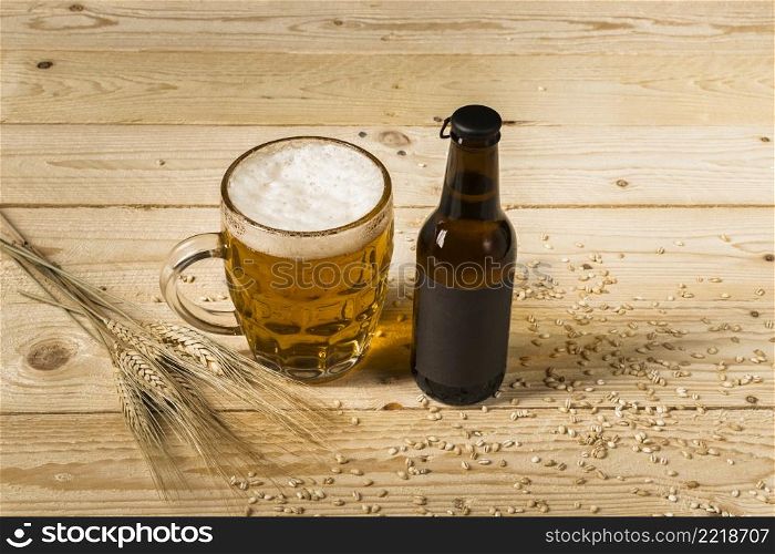 close up beer glass bottle with ears wheat wooden background