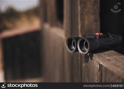 close up binoculars wooden ledge