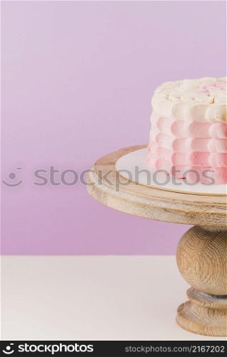 close up birthday cake wooden cakestand