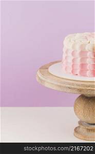 close up birthday cake wooden cakestand