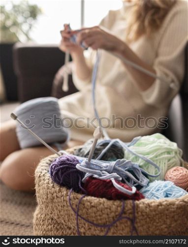 close up blurry woman crocheting
