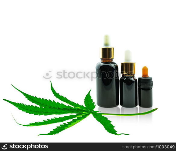 Close up Bottle with CBD oil and cannabis leaf at white background, medical marijuana concept