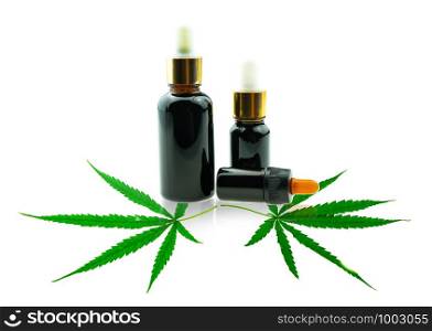Close up Bottle with CBD oil and cannabis leaf at white background, medical marijuana concept