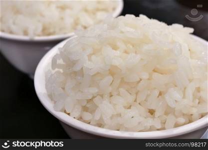 Close up bowl of cooked rice on table