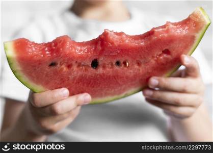 close up boy eating watermelon