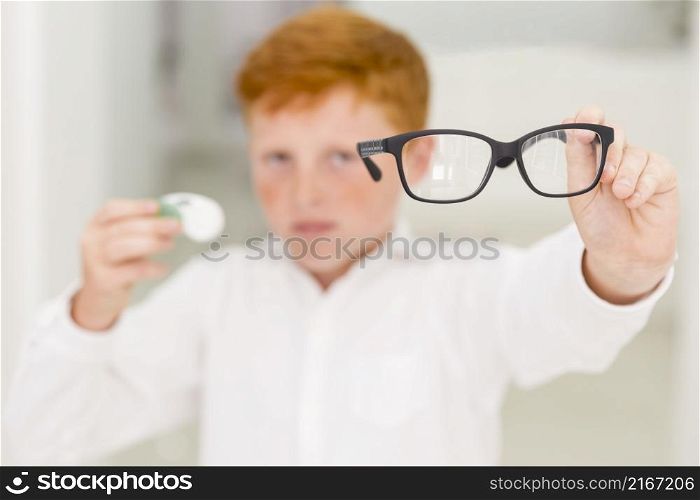 close up boy showing black frame eyeglasses