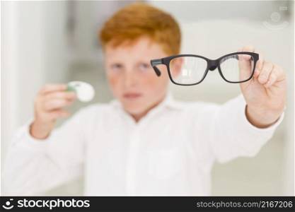 close up boy showing black frame eyeglasses
