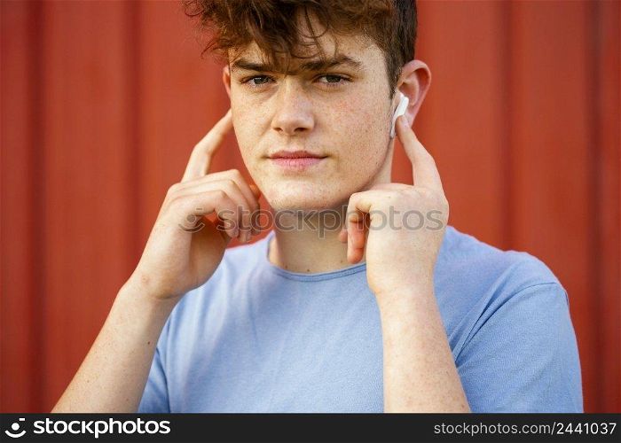 close up boy using wireless earphones