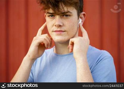 close up boy using wireless earphones