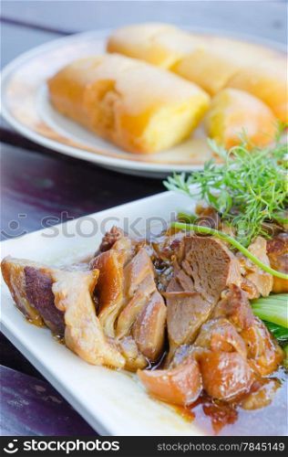 close up braised pork belly on white dish , chinese style cuisine