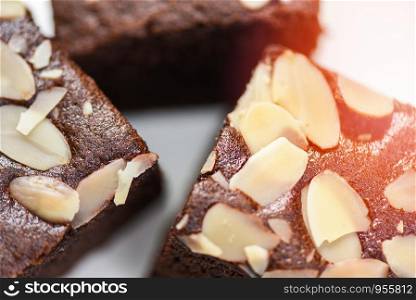 Close up brownies cake slice with nut on plate