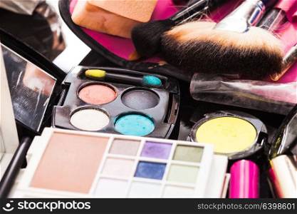 Close up brushes and cosmetic products on the table, vivid colors. Cosmetics set close up