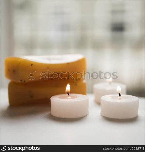 close up burning candles soaps spa