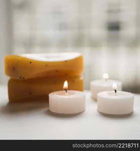 close up burning candles soaps spa