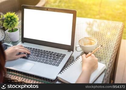 Close-up business female working with laptop make a note and Alarm clock on outdoors