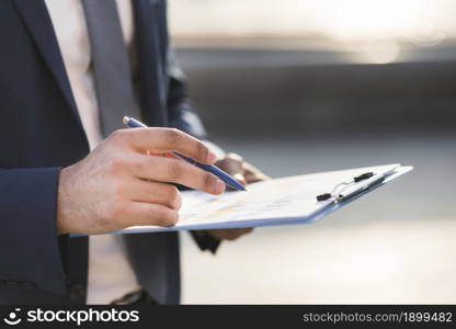 close up business man checking clipboard. Resolution and high quality beautiful photo. close up business man checking clipboard. High quality beautiful photo concept