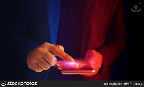 Close up business man formal blue suit Use hold smart phone in the dark. warning smart phone security. virus alert.