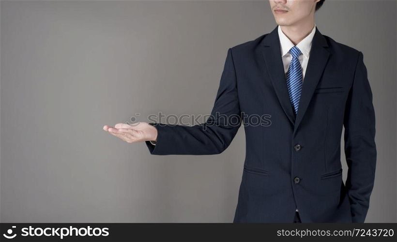 Close up Business man is holding something , grey background in studio
