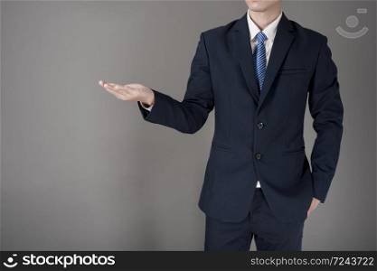 Close up Business man is holding something , grey background in studio