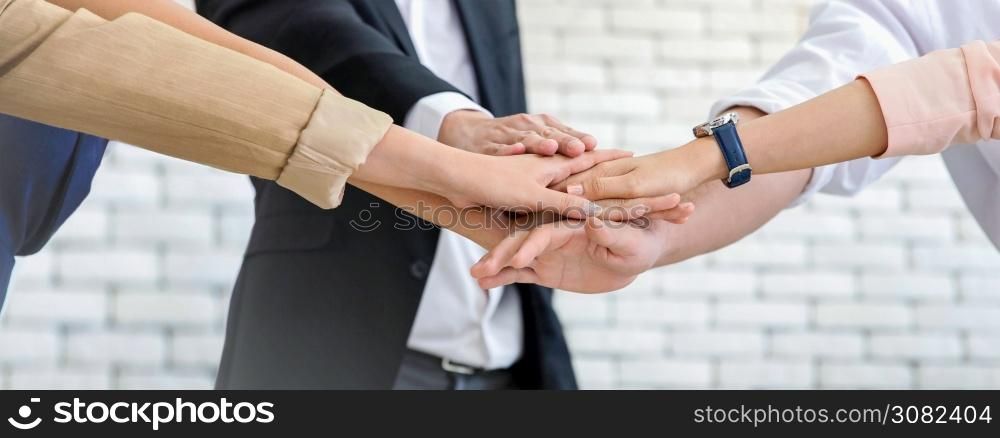 Close up business team of young man and woman showing unity with their hands together , unity success and teamwork concept.