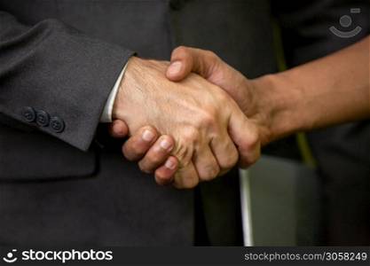 close up businessman hand shake