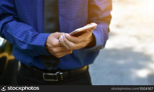 Close up businessman holding mobile smart phone
