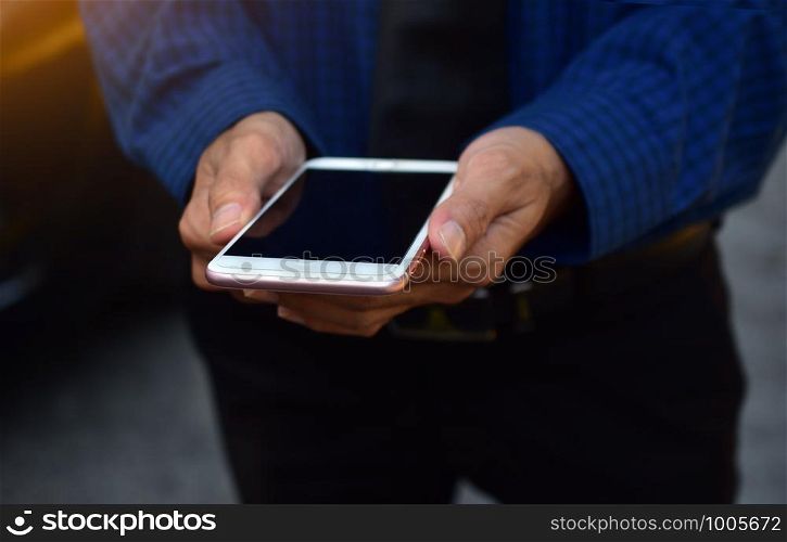 Close up businessman holding mobile smart phone